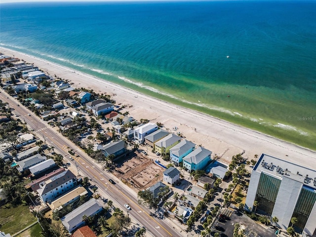 bird's eye view with a water view and a beach view