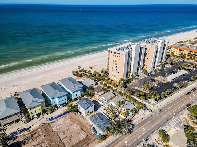 bird's eye view featuring a view of the beach and a water view