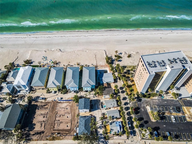 bird's eye view featuring a water view and a beach view