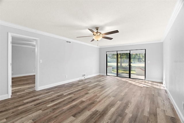 unfurnished room featuring ceiling fan, a textured ceiling, dark hardwood / wood-style floors, and crown molding