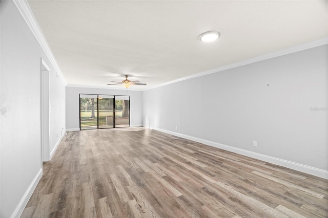 empty room with ceiling fan, ornamental molding, and light hardwood / wood-style floors