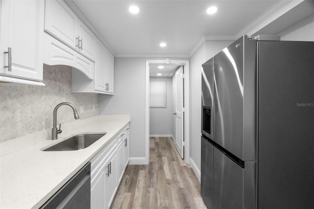 kitchen with white cabinetry, black dishwasher, sink, stainless steel fridge with ice dispenser, and ornamental molding