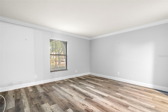 unfurnished room featuring wood-type flooring and crown molding