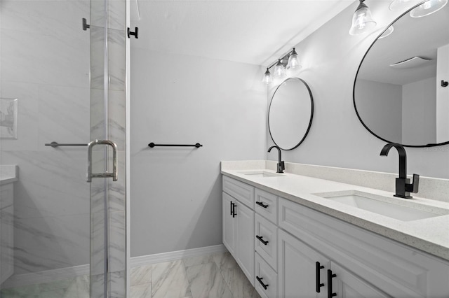 bathroom with a shower with shower door and vanity