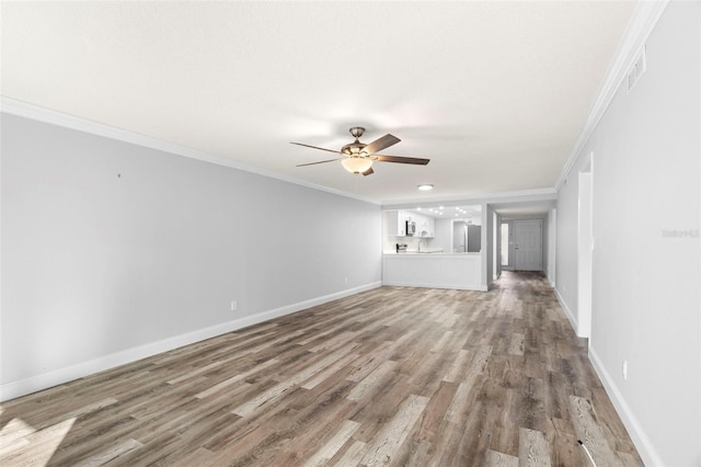 unfurnished living room featuring ceiling fan, light wood-type flooring, and ornamental molding