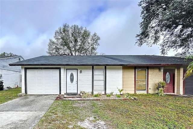 ranch-style house featuring a garage and a front lawn