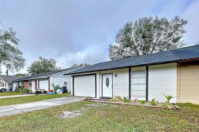 single story home featuring a front yard and a garage