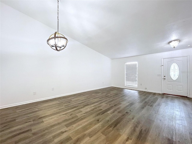 foyer with dark hardwood / wood-style floors and an inviting chandelier