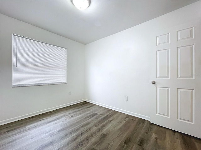 spare room with dark hardwood / wood-style flooring