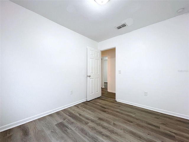 empty room with dark wood-type flooring