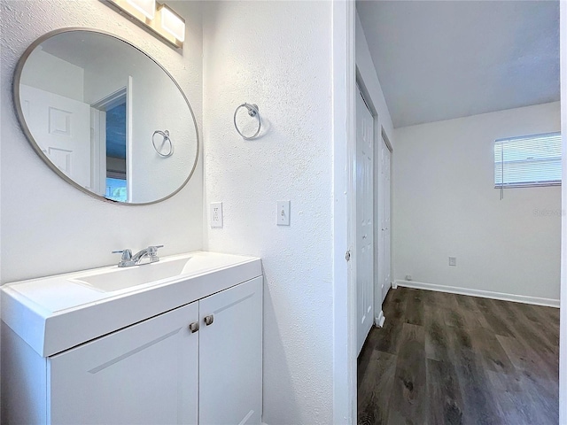 bathroom featuring hardwood / wood-style flooring and vanity