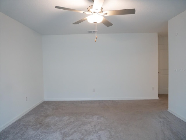 empty room featuring ceiling fan and light colored carpet