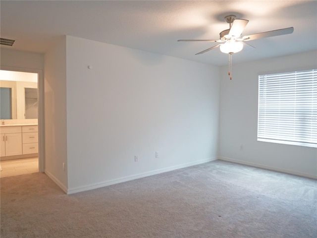 unfurnished room with ceiling fan and light carpet