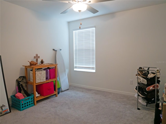 game room with light carpet and ceiling fan