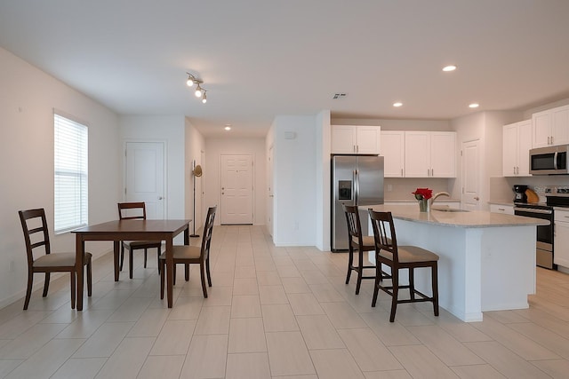 22547 Storybook Cabin Way, Land O Lakes, FL 34637 - kitchen with white cabinets, a sink, stainless steel appliances, recessed lighting, and visible vents