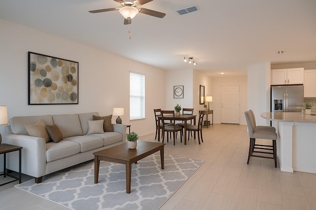 22547 Storybook Cabin Way, Land O Lakes, FL 34637 - living room featuring visible vents, baseboards, and ceiling fan