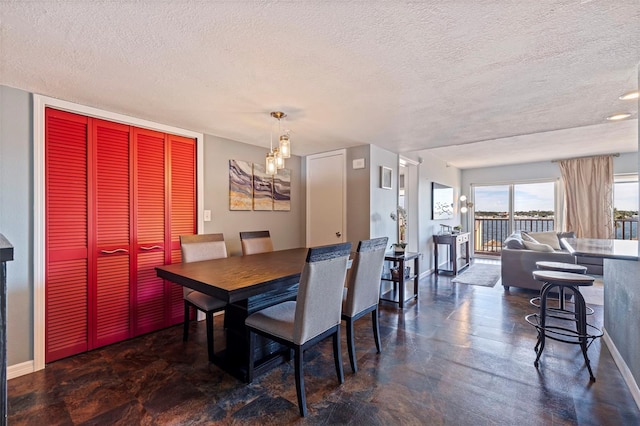 dining space with a textured ceiling