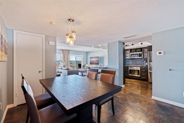 dining space featuring a textured ceiling