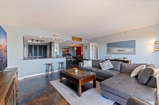 living room with a textured ceiling