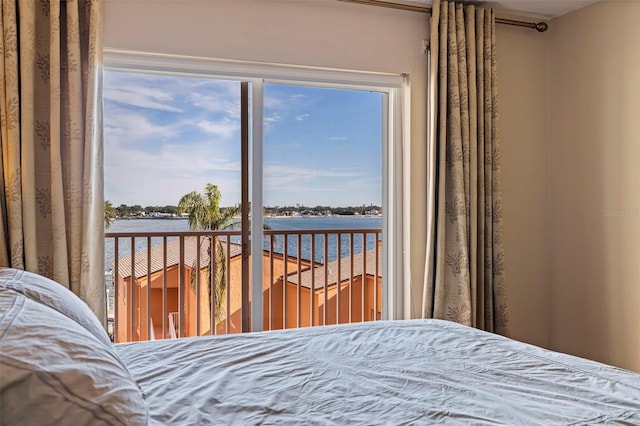 bedroom featuring a water view