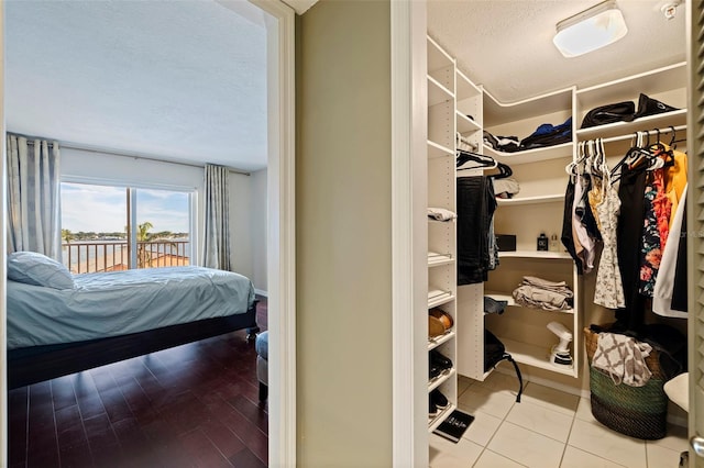 spacious closet featuring light tile patterned flooring