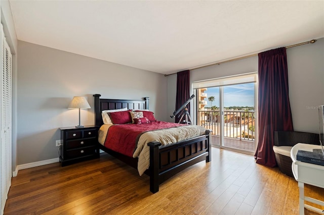 bedroom with hardwood / wood-style floors and access to exterior