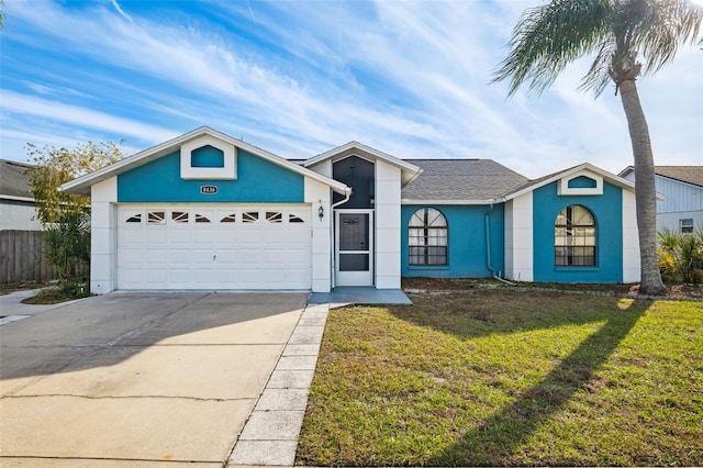 ranch-style house featuring a front yard and a garage