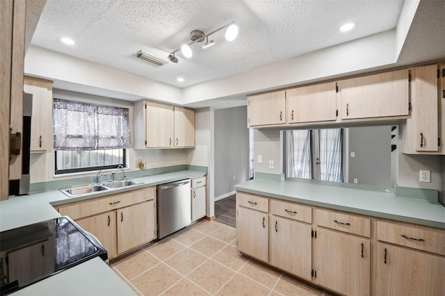 kitchen featuring light brown cabinetry, stainless steel dishwasher, and sink