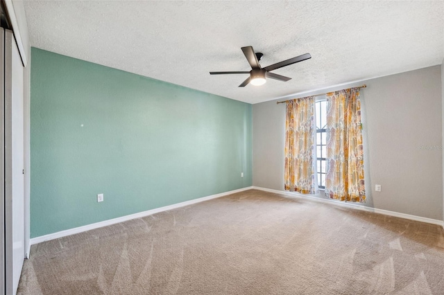 spare room with ceiling fan, carpet floors, and a textured ceiling