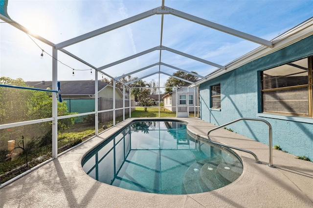 view of swimming pool with glass enclosure