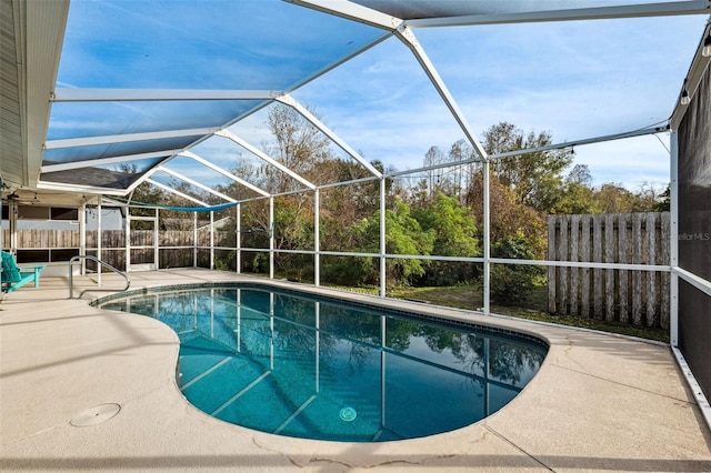 view of swimming pool featuring a lanai and a patio area