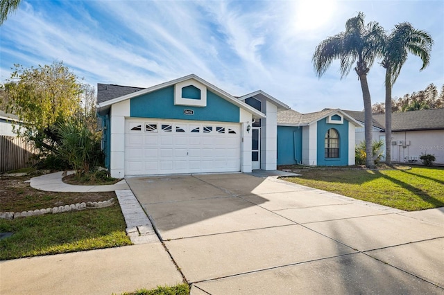 single story home featuring a garage and a front yard