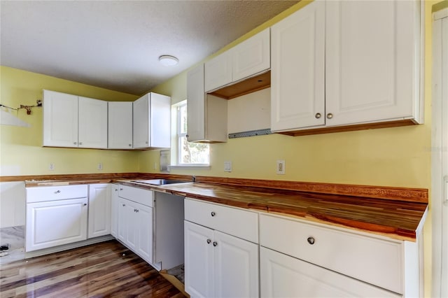 kitchen featuring wood counters, white cabinets, and dark wood-type flooring