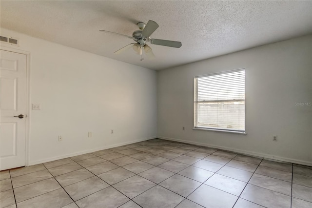 unfurnished room with a textured ceiling, ceiling fan, and light tile patterned flooring