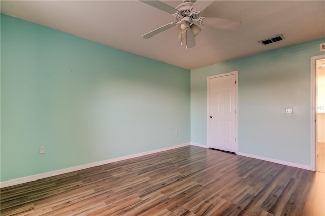 empty room featuring hardwood / wood-style flooring and ceiling fan