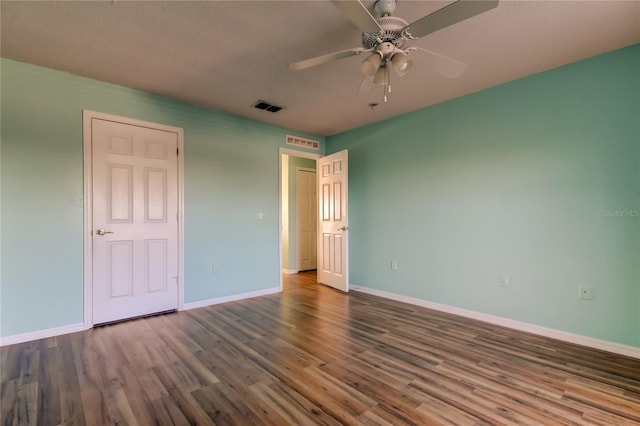 unfurnished bedroom featuring ceiling fan and dark hardwood / wood-style floors