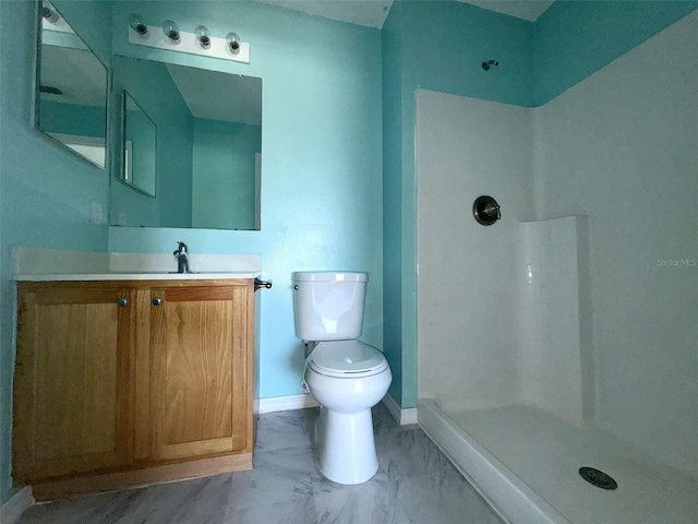 bathroom with toilet, vanity, and walk in shower