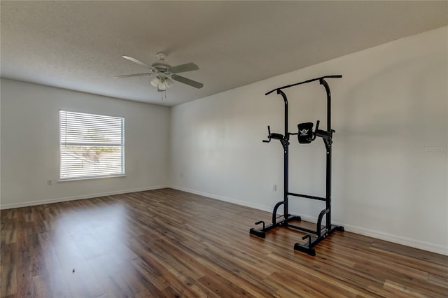 workout area featuring a textured ceiling, ceiling fan, and dark hardwood / wood-style floors