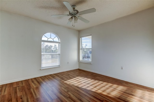 spare room featuring a textured ceiling, hardwood / wood-style flooring, and ceiling fan