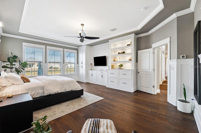 bedroom with dark hardwood / wood-style flooring, crown molding, a raised ceiling, and ceiling fan