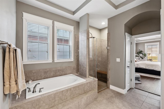 bathroom with tile patterned floors and shower with separate bathtub