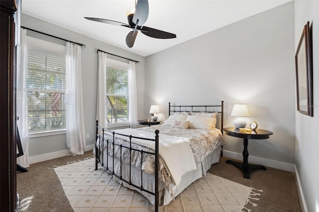 bedroom featuring light carpet and ceiling fan