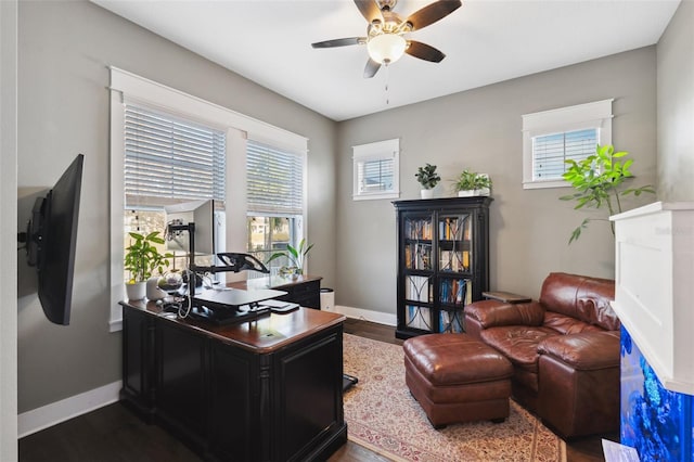 office with dark hardwood / wood-style flooring and ceiling fan