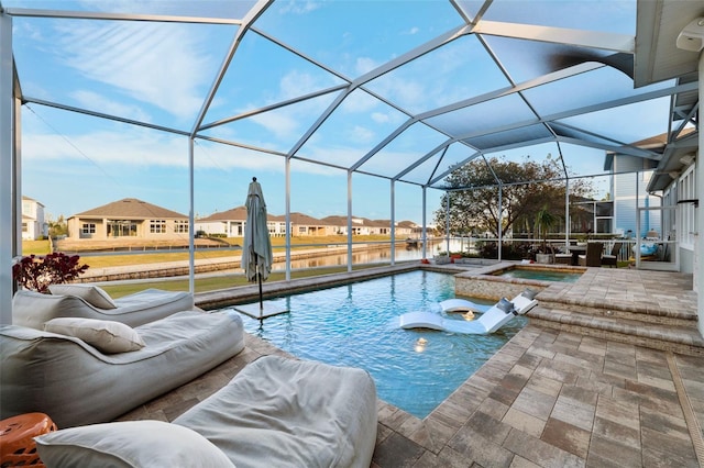 view of swimming pool featuring a lanai, a patio area, and an in ground hot tub