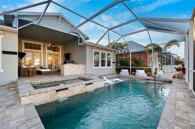 view of swimming pool with ceiling fan, a patio, glass enclosure, an outdoor living space, and an in ground hot tub