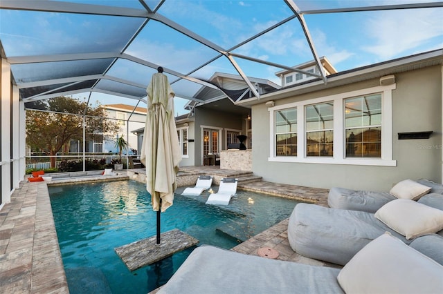 view of pool with a patio and glass enclosure