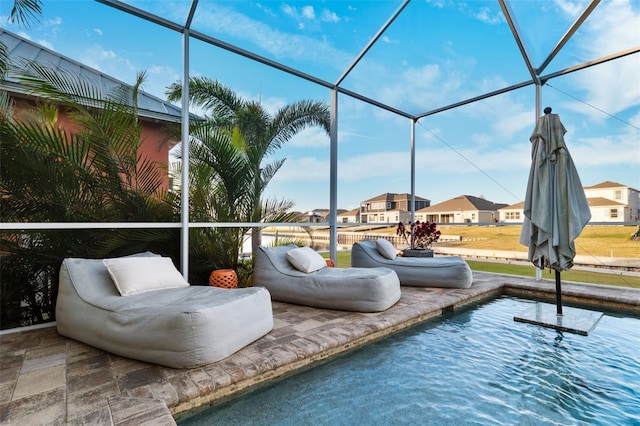 view of swimming pool featuring glass enclosure