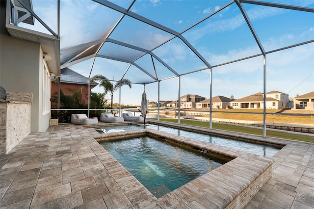 exterior space featuring a lanai, a patio, and an in ground hot tub