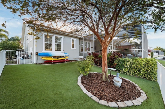 view of yard with glass enclosure and a fenced backyard