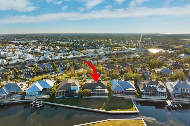 drone / aerial view featuring a residential view and a water view